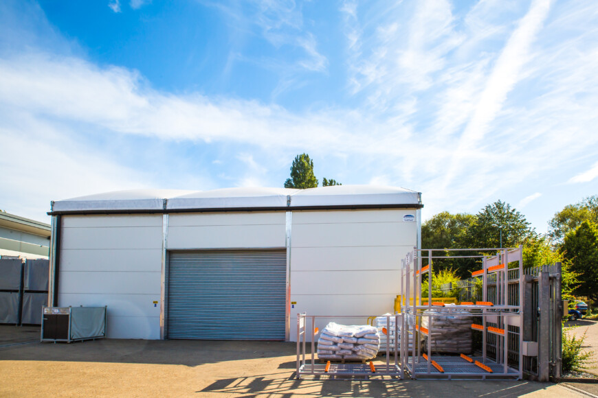 White-temporary-building-with-grey-roller-shutter-door