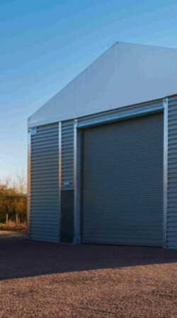 Aganto-temporary-solution-with-roller-shutter-door-for-vehicle-access