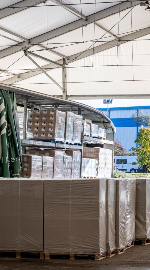 Green truck in aganto temporary loading bay