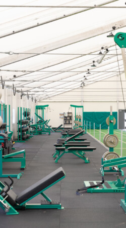 weight stations in a temporary gym building