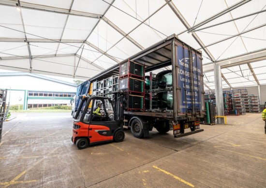 AGC Glass loading products onto truck in Aganto temporary canopy